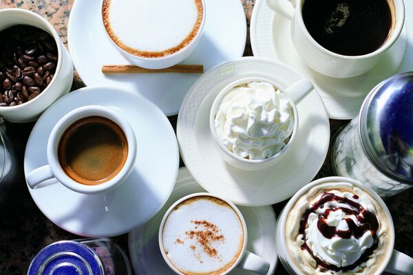 Several types of coffee in beautiful white mugs