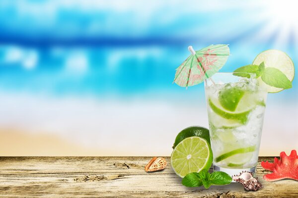 Mojito with lime in a glass on a blue background