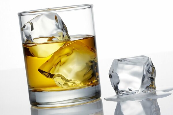 Transparent ice cubes in a glass of whiskey
