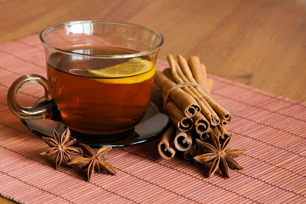 A cup of tea with cinnamon and lemon