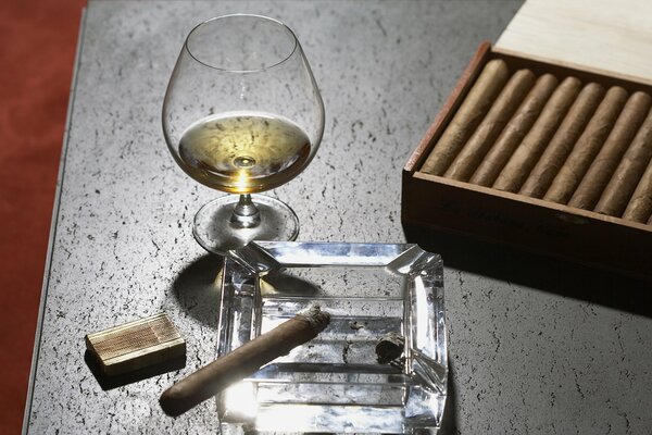 Cigar packaging and alcohol in a glass