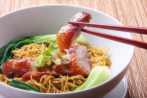 Noodles with meat. Delicious food, green decoration