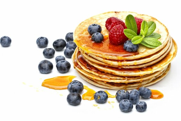 Fresh pancakes with berries and honey