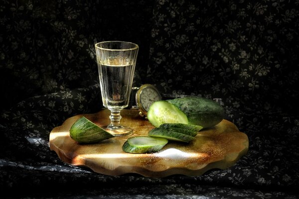 Sliced cucumber on the background of a clock and a stack