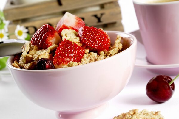 Sweet dessert with strawberries and cherries in a pink plate