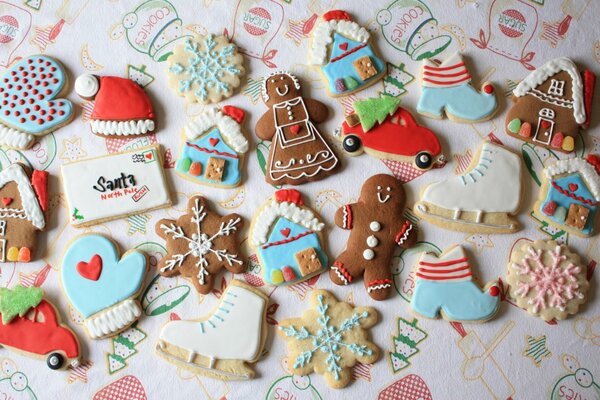 Christmas cookies in the form of classic gingerbread men and other New Year and winter symbols: snowflakes, mittens, skates, houses, cars with a Christmas tree