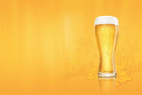 A glass of foam on a patterned yellow background