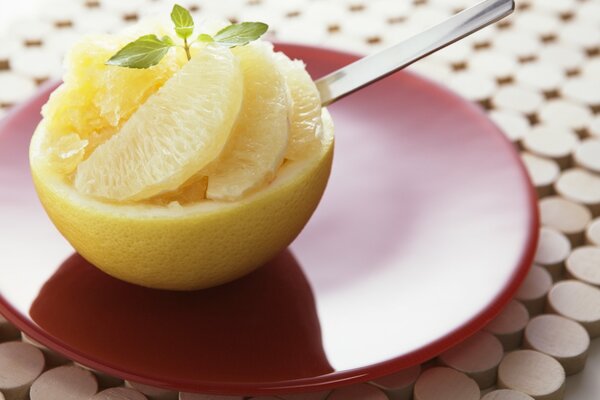 Dessert of grapefruit slices on a red plate