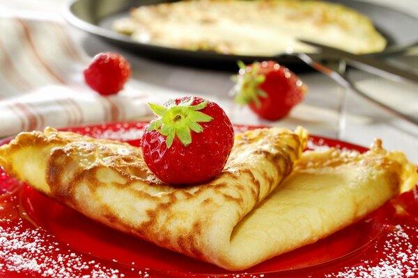 Pancakes with strawberries and jam for dessert