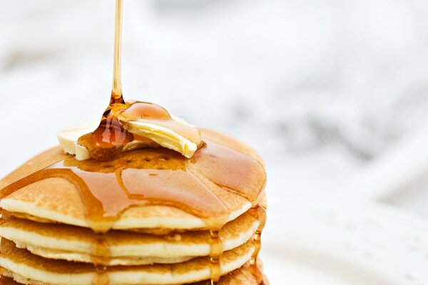 Pancakes poured with fresh honey