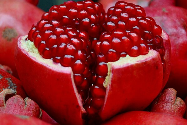 An open red pomegranate in the peel