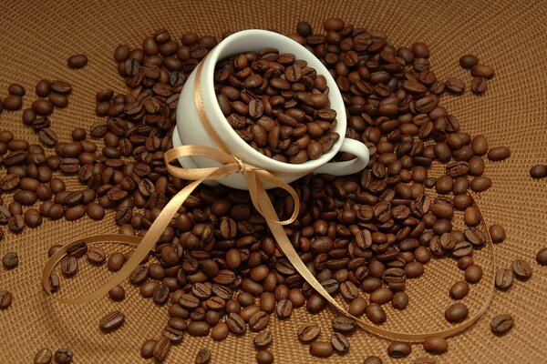 Mug with coffee beans on the macro