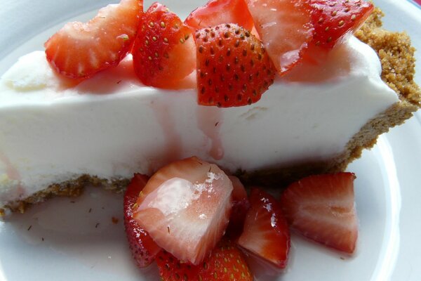 Strawberry slices on a piece of cake in a plate