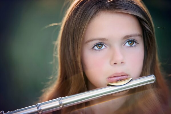 Portrait of a girl with a flute in the sunlight