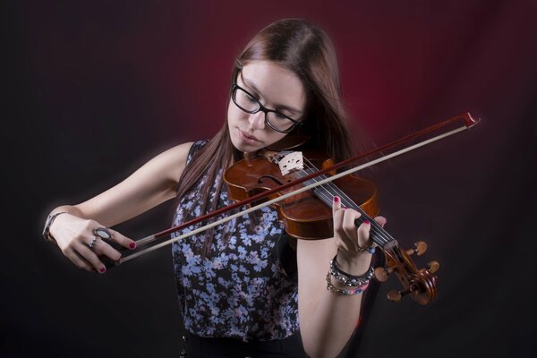 A girl with long hair plays the violin