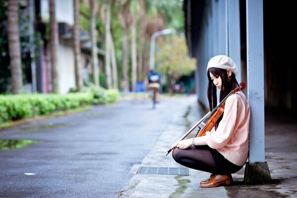 Girl with a violin sitting