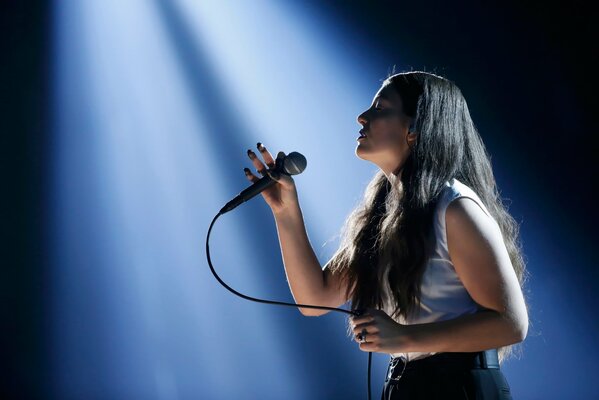 New Zealand singer Lorde with a microphone on stage