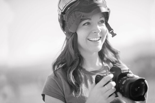 Girl photographer in a helmet