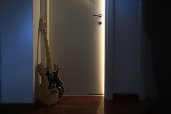 Elegant guitar on the background of the doorway