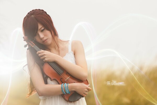 Beautiful girl in a wreath with a violin