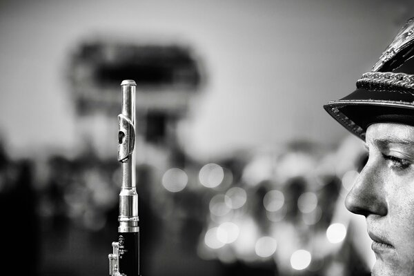 The flute player of the military orchestra in black and white photo