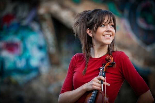 Beautiful Lindsay Stirling holds a violin