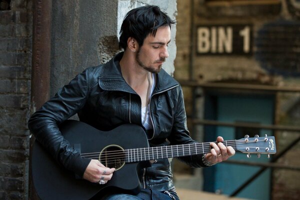 Photo of Adam gontier playing guitar