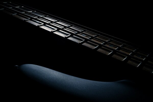 Guitar neck on a black background