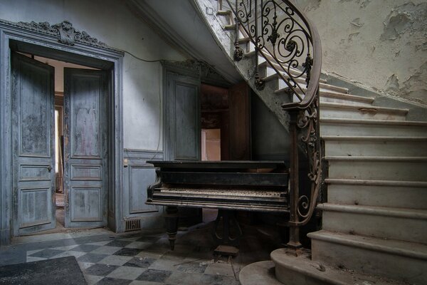 Antique spiral staircase and piano