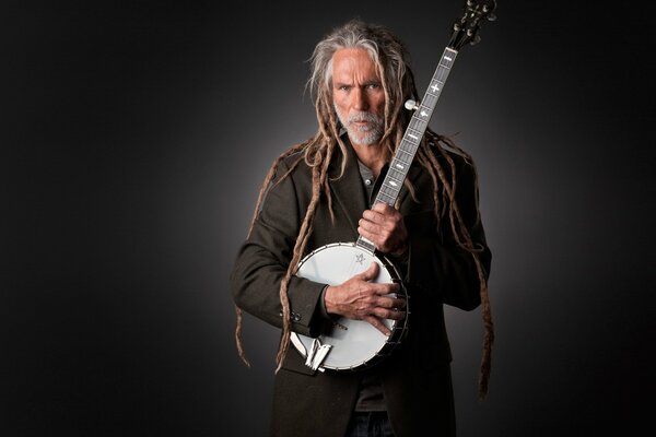 Musician in dreadlocks with a banjo