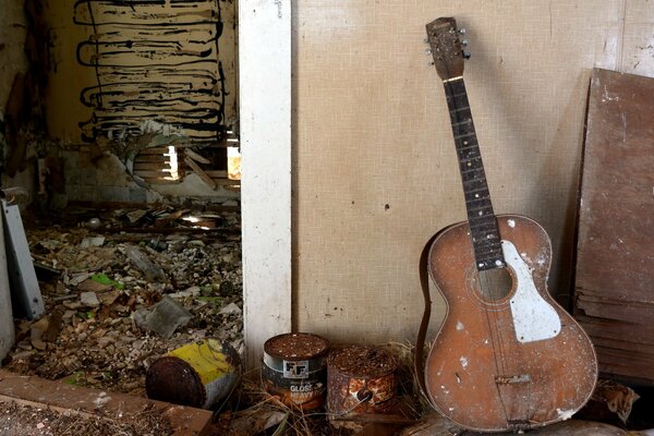 An old guitar in an abandoned house