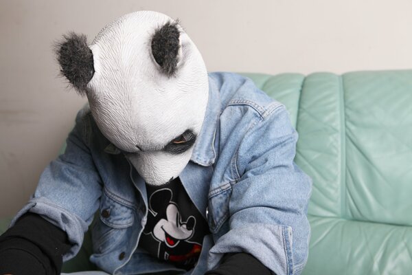 Panda mask is worn by a man with a denim jacket
