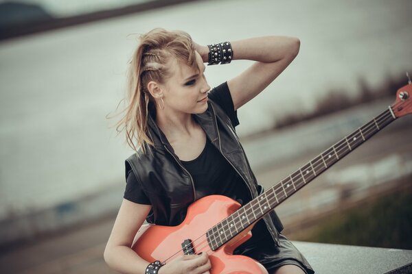 Beautiful rocker girl with guitar