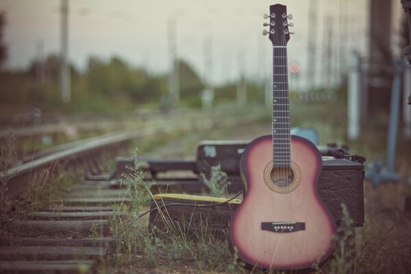 Guitar on the background of the railway