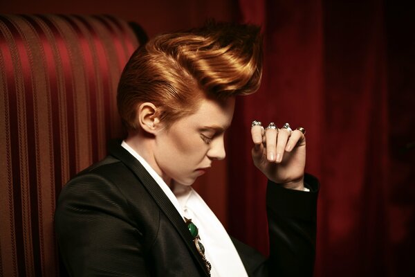 A red-haired singer in a classic suit
