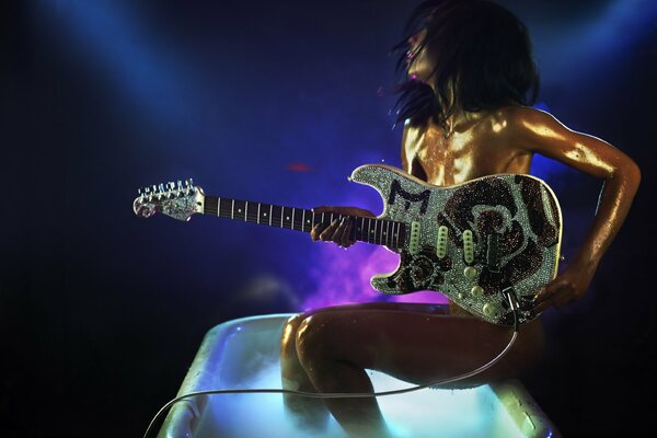 A girl with a guitar in a huge glass