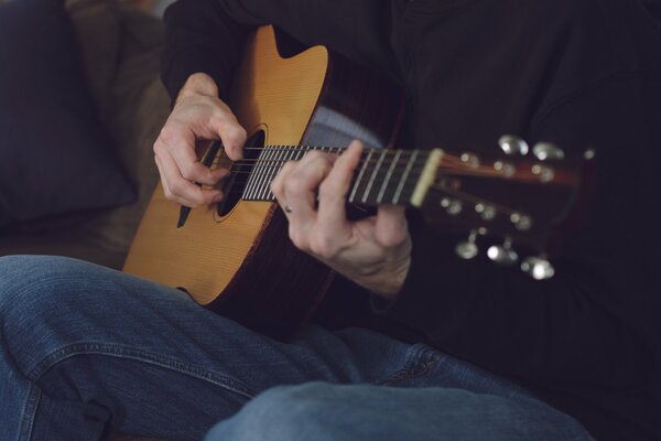 The musician touches the strings with his fingers