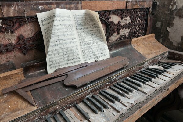 An old dusty piano with a book of music