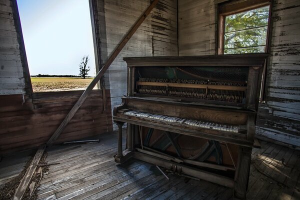 An old piano in a crumbling house