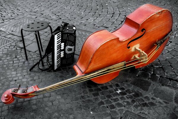 There is an accordion and a violin on the street