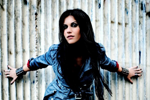 A girl against a background of gray metal fences