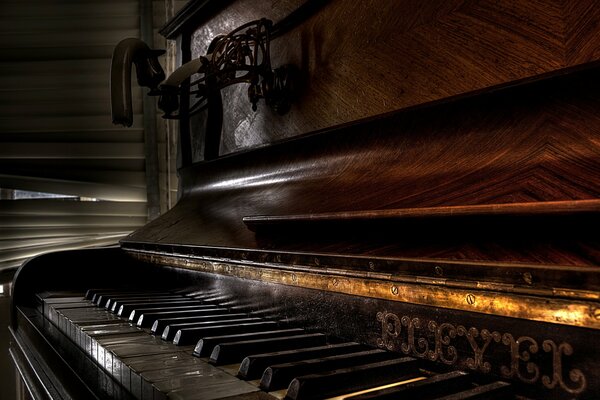 Piano with candles by the window