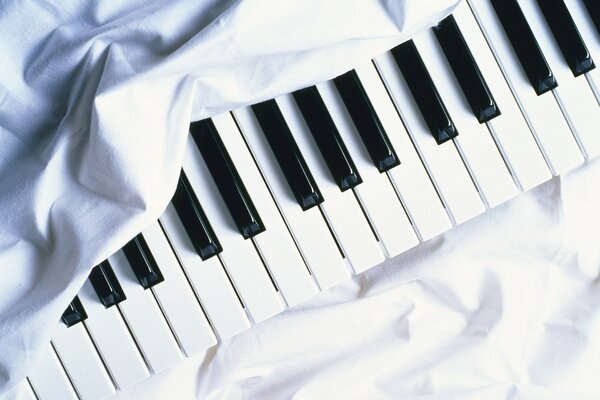 Piano keys under a white cloth