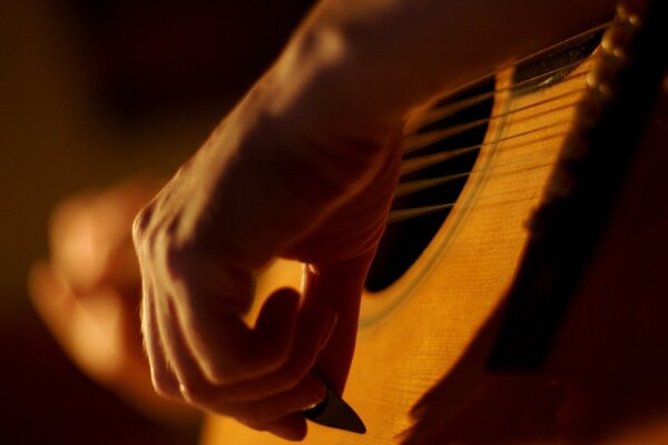 The musician plays the guitar beautifully