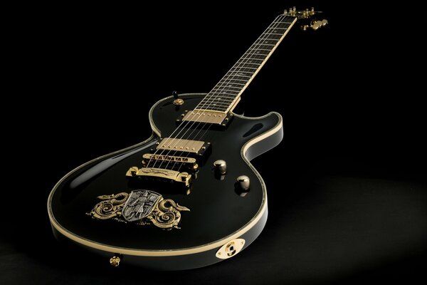 Black guitar with gold decor