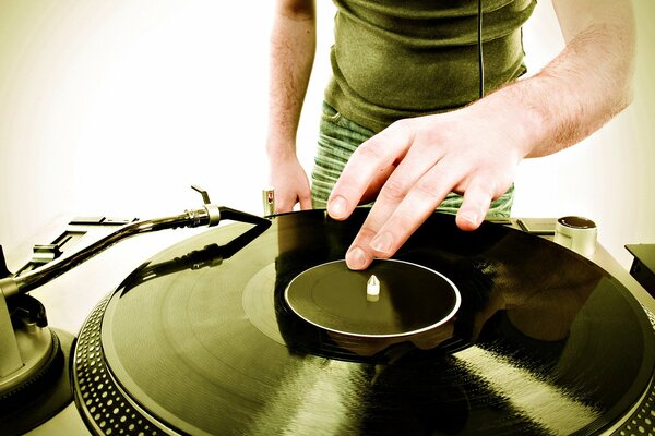 DJ s hands on a vinyl record