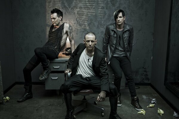 Trzech wokalistów Linkin Park na tle stołu