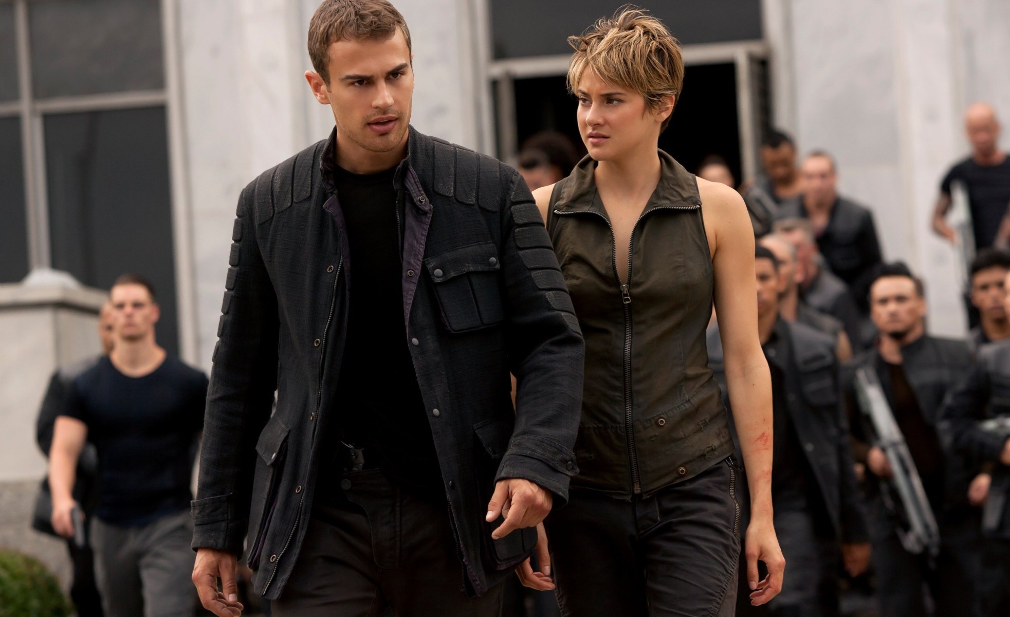 divergent row action man divergent 2 theo james four woodley tris beatrice do gun pistol jacket man woman girl soldiers resistance factions rebels subversive takeover wanted