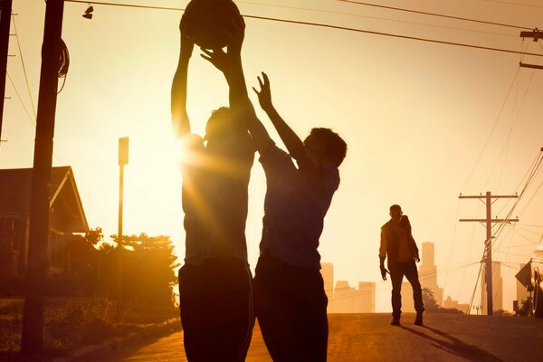 Poster from the TV series Fear the walking Dead with boys playing basketball.