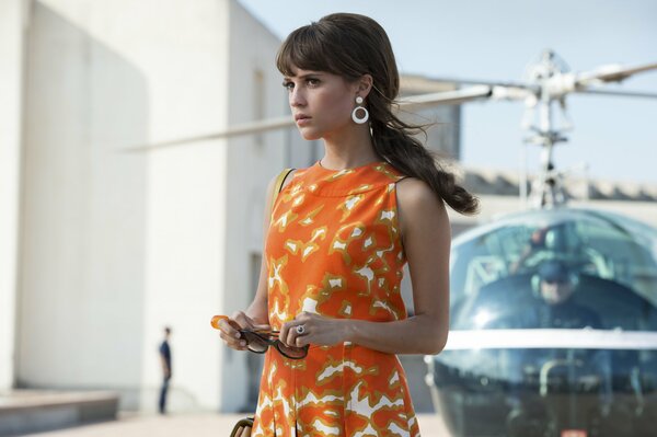 Alicia Vikander near the helicopter